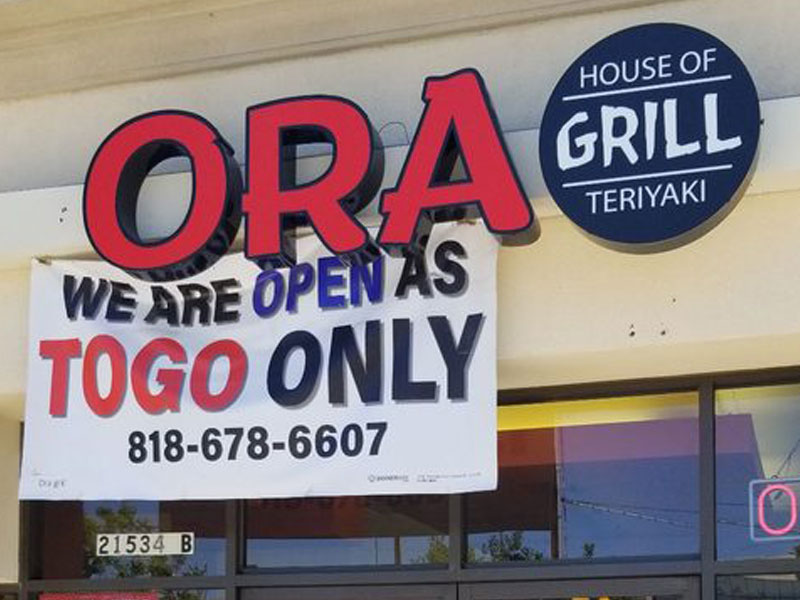 ora grill store front photo of logo sign above door